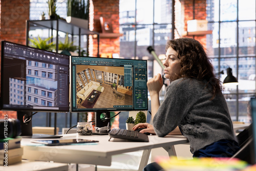 Photos Woman developer works on an interior design project using CAD software to create a detailed floor plan, virtual assets