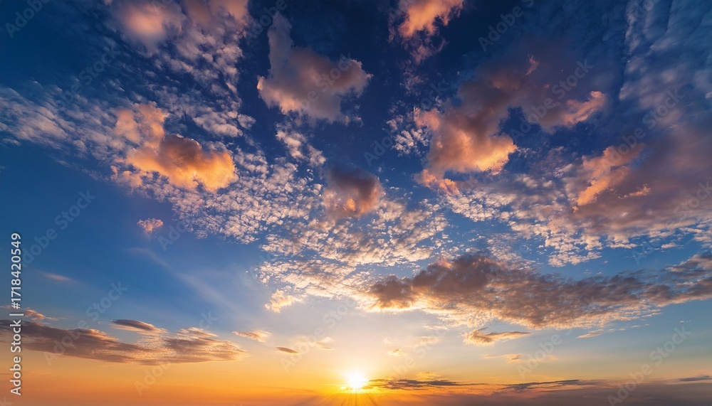 Obraz premium The Sky Is Filled With Clouds And The Sun Is Setting Creating A Beautiful And Serene Atmosphere