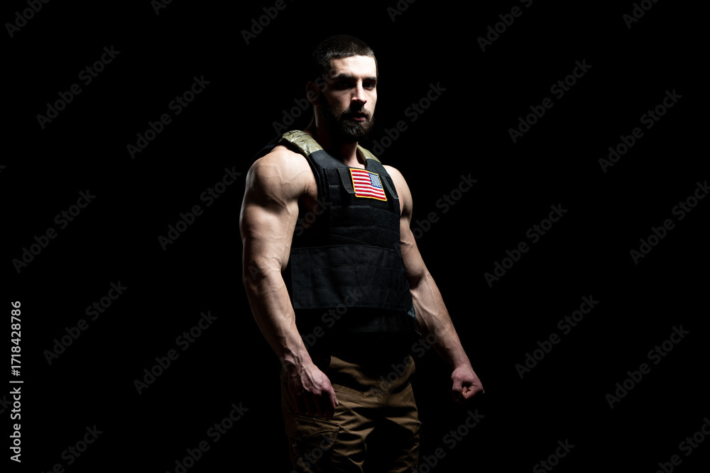 Naklejka premium Bodybuilder Soldier With Bulletproof Vest on Black Background