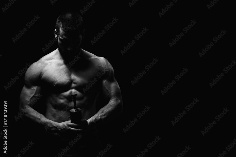 Fototapeta premium Young Man Holding a Bomb on Black Background