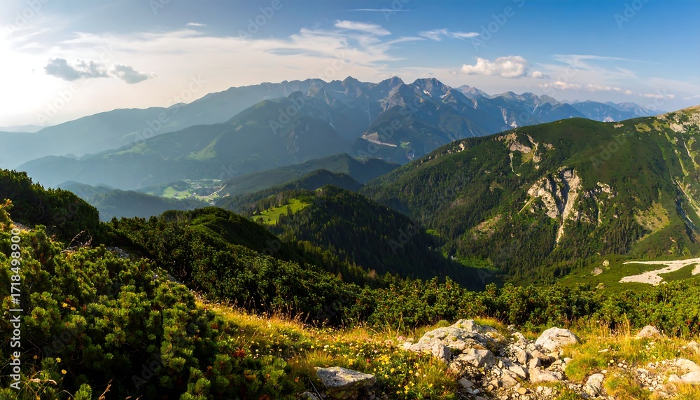 Naklejka premium Panoramic mountain vista, lush valleys, and rolling hills