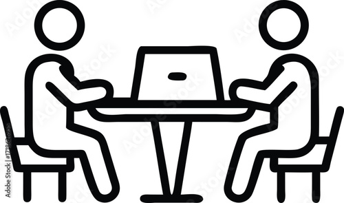 Two individuals at a table with a laptop, symbolizing a business meeting or work session collaboration
