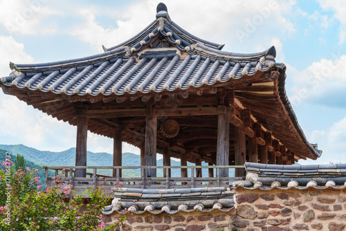 A view of Byeongsan Seowon, a UNESCO World Heritage Site in Andong, Korea, with red Crape Myrtle flowers in full bloom.