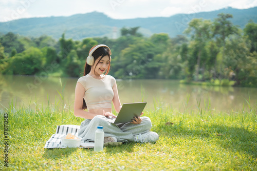 Wallpaper Mural A young woman enjoys spending time writing and reading in the park. Torontodigital.ca