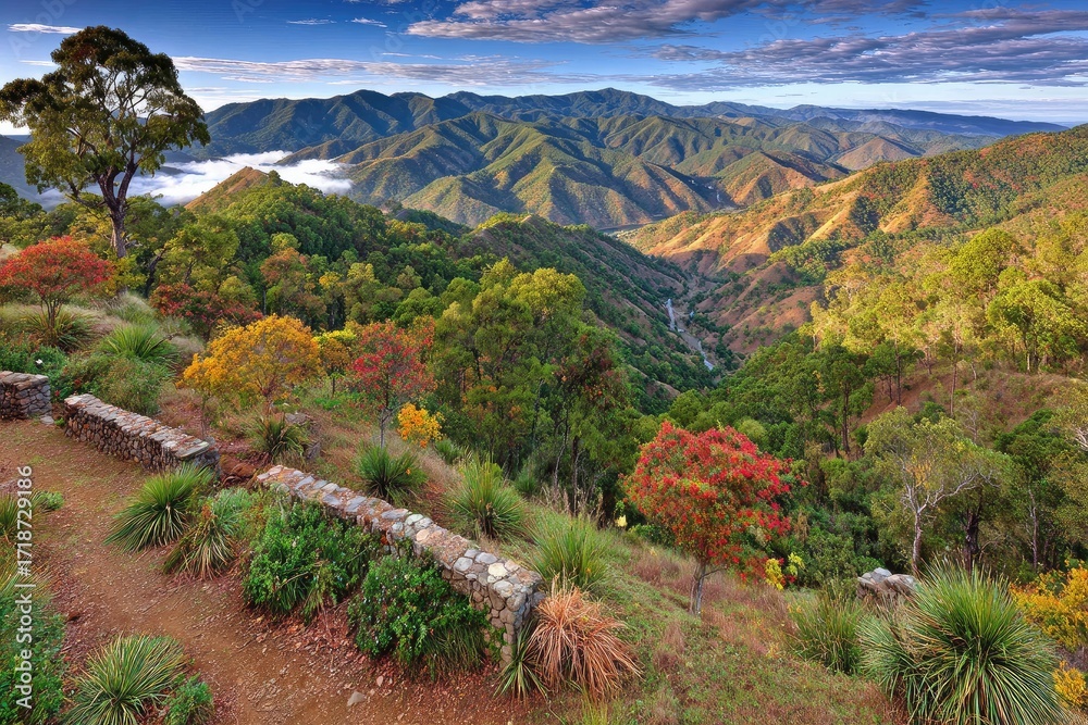 Fototapeta premium Mountain valley vista with colorful foliage and low stone walls
