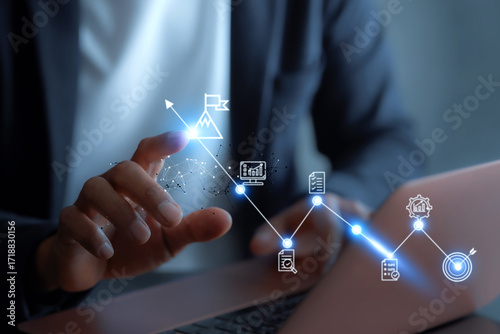  business goals concept. Businessman analyzes graph of trend market growth in 2025 and plans business growth and profit increases. calculates financial data for long-term investments.