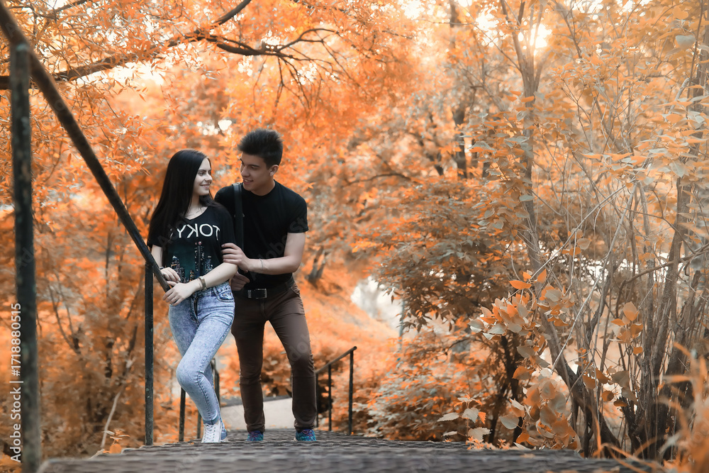 Fototapeta premium Young couple on a walk in autumn park