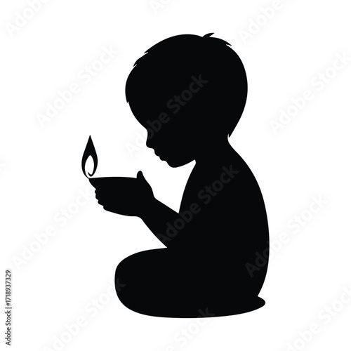 Silhouette of a child holding a diya for Diwali celebration light and hope