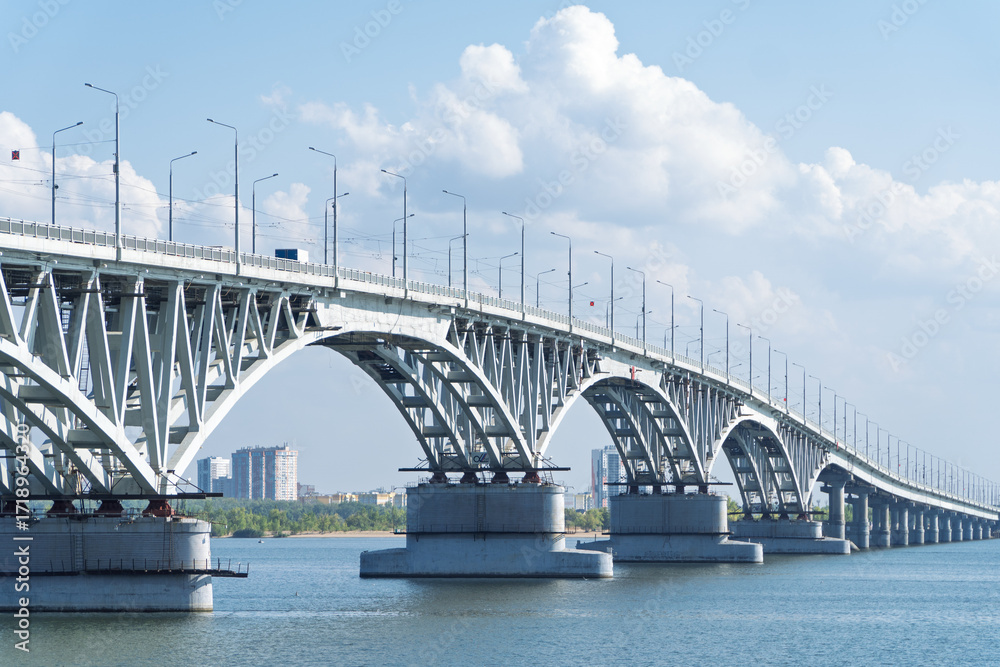 Obraz premium The bridge through the river Volga. Saratov.The bridge over the Volga River between the cities of Saratov and Engels. Panorama of the city and the Saratov bridge across the Volga river. Russia. 
