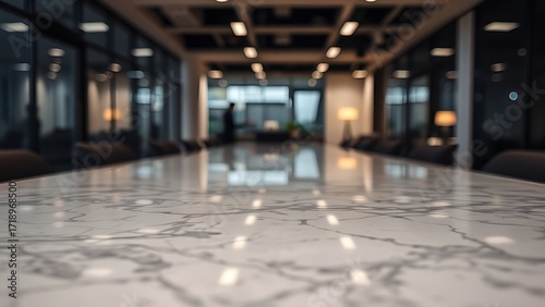 Polished marble tabletop reflecting abstract shapes with a blurred office environment in the background.
