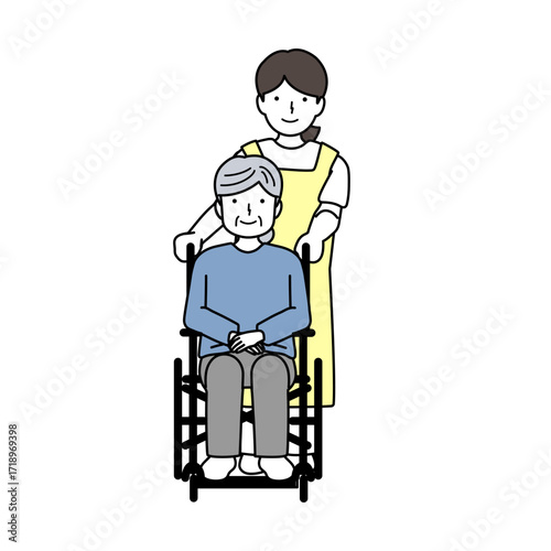 高齢者の車椅子を介助する介護士
