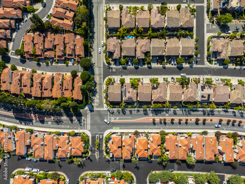 Top-down aerial view of symmetrical suburban neighborhood with red tile rooftops and intersecting streets in Long Beach, California