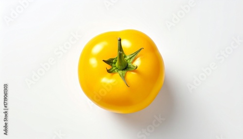 A vibrant yellow tomato with a glossy surface and green stem, isolated on a clean white background