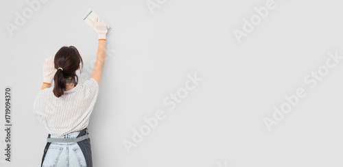 Female worker with putty kn...