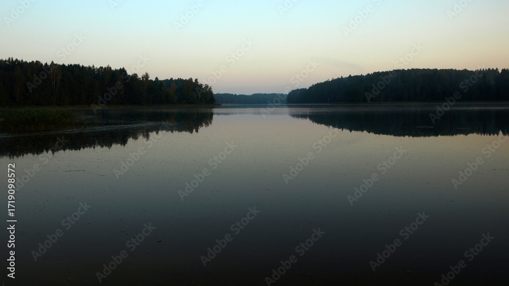 Fototapeta premium sunrise landscape by the lake, calm and quiet morning, morning dew on the meadow, autumn vegetation