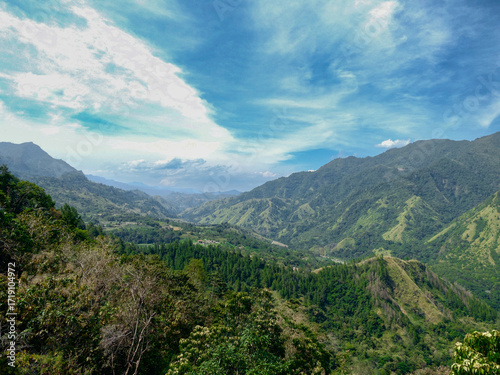 Mountains covered in lush vegetation with a river running through the valley in Gunung Nona, South Sulawesi, Indonesia- Gunung Nona, Enrekang Regency, South Sulawesi, Indonesia