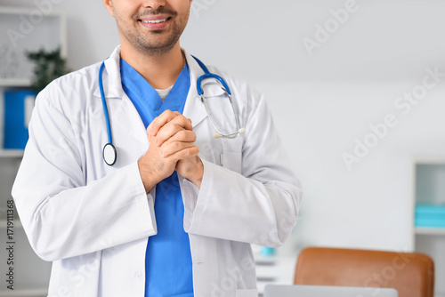 Smiling male doctor in whit...