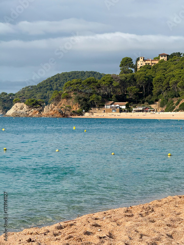 Sunny beach view with blue sea water horizon sandy coastline seascape summer vacation travel tourism ocean waves nature landscape