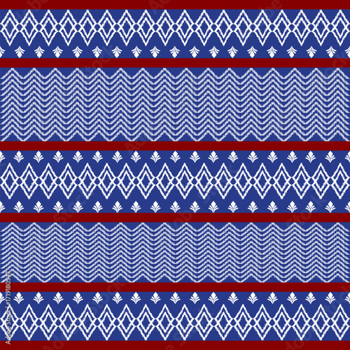 Motif ethnic ikat pattern seamless textile. Antique pattern, white flowers, navy blue and red background.