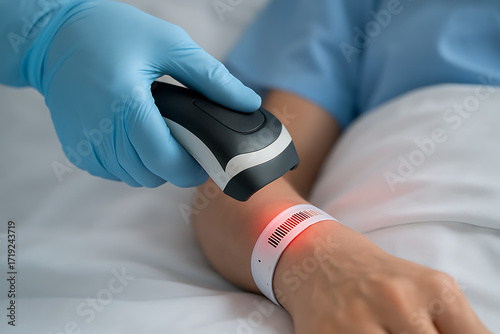 A close-up image of a healthcare worker scanning a patient’s wristband using a barcode reader. The red light reflects accuracy in patient identification, hospital safety protocols, and digital record 