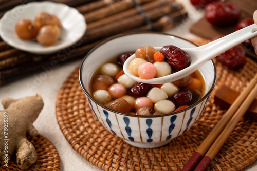 Homemade red and white tangyuan with syrup soup, dried longan pulp, red dates for Winter solstice.