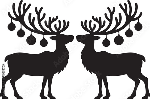 Two black reindeer silhouettes facing each other with Christmas ornaments hanging from their antlers