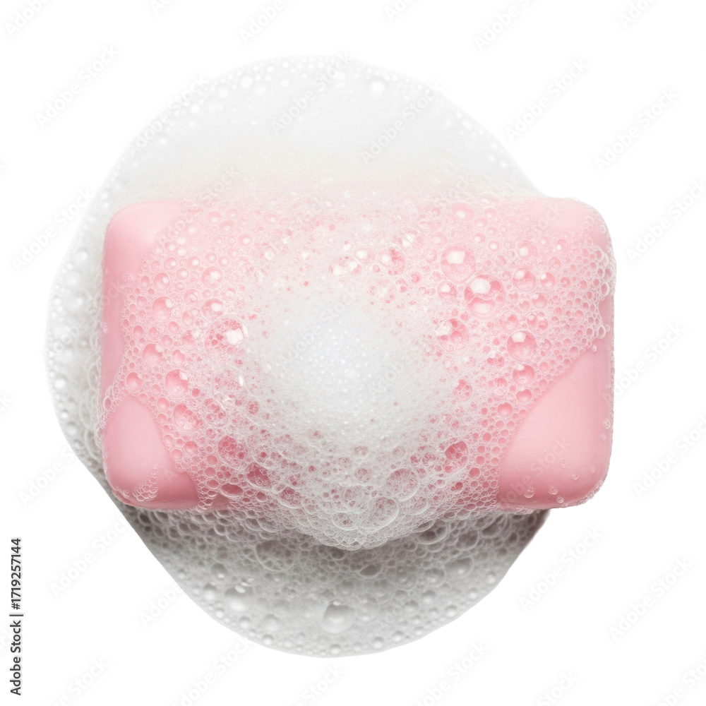Fototapeta premium Soft pastel pink soap bar, glistening wet, covered in frothy white suds and iridescent bubbles, isolated on a bright white background with copy space, concept of pristine hygiene and freshness
