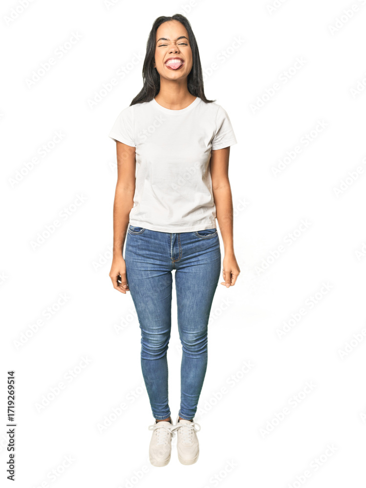 Obraz premium Full body shot of Latina in studio funny and friendly sticking out tongue.