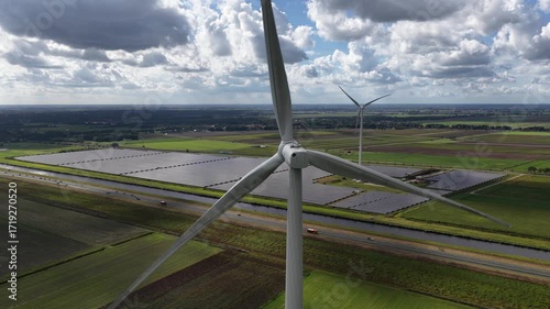 Wind turbines and solar panels in 60 fps, clean energy, renewabale energy. Sustainable energy production. Groningen, The Netherlands.