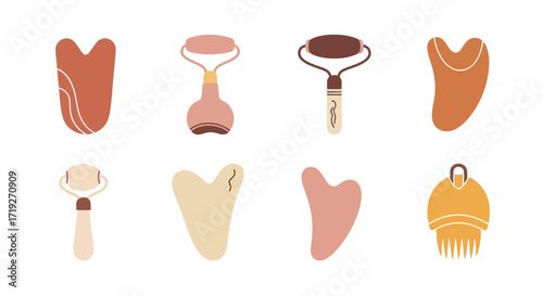 Collection of facial massage tools including gua sha stones and jade rollers.