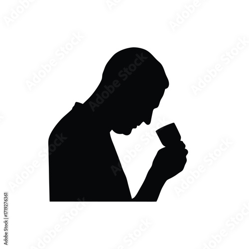 Silhouette of a man holding a small glass and smelling it against a white background space around