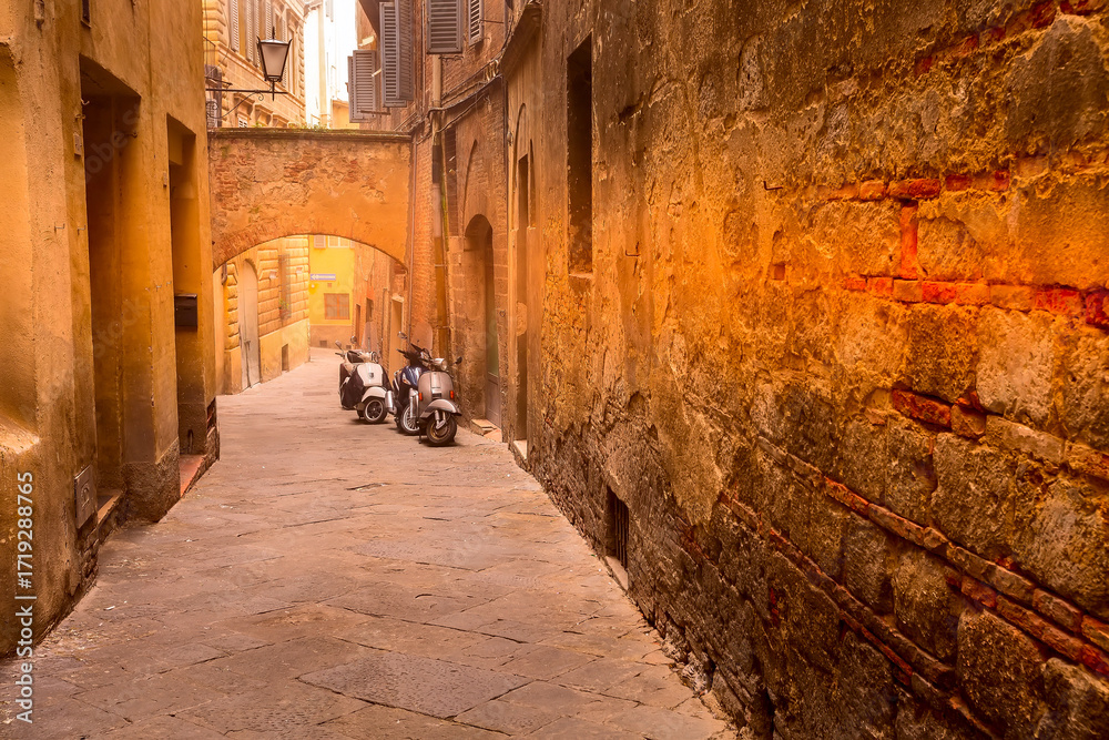 Naklejka premium Street view in Siena, Italy and scooter