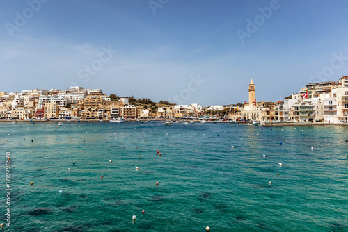 Wallpaper Mural Panoramic view of the Marsaskala waterfront with colorful buildings, boats, and clear turquoise water on a sunny spring day, Malta, Europe Torontodigital.ca