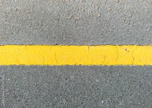 yellow shoulder line on asphalt road textured background, close up hi-res image 