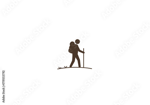 A hiker silhouette walks with a walking stick on a small hill