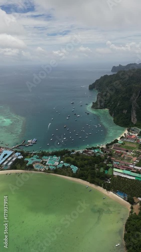 Drone video in portrait of Koh Phi Phi Don with Longtail Boats