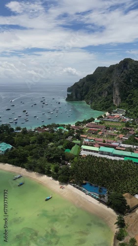 Drone video in portrait of Koh Phi Phi Don with Longtail Boats