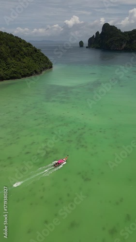 Drone video in portrait of Koh Phi Phi Don with Longtail Boats