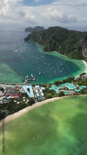 Drone video in portrait of Koh Phi Phi Don with Longtail Boats