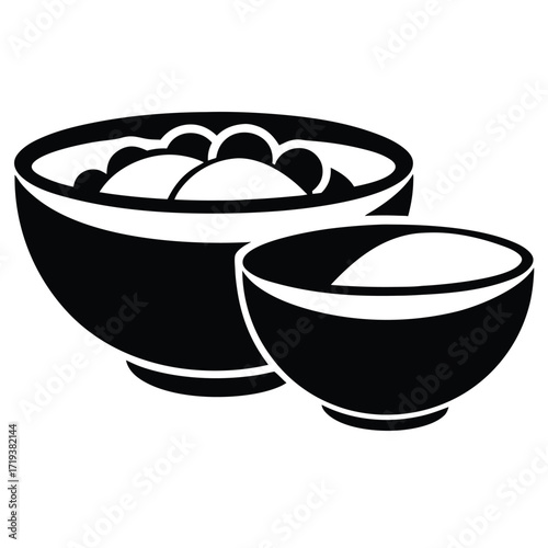 Two contrasting bowls display their contents in a minimalistic, striking, monochrome culinary setting