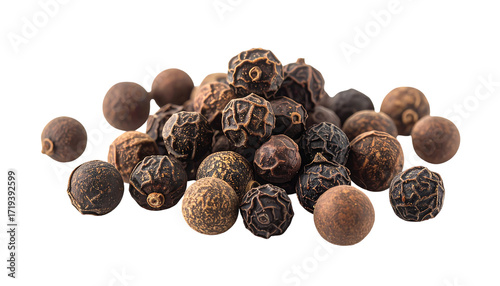 A small pile of dark brown and black peppercorns, round and wrinkled,  showing varied shades and textures against a black background