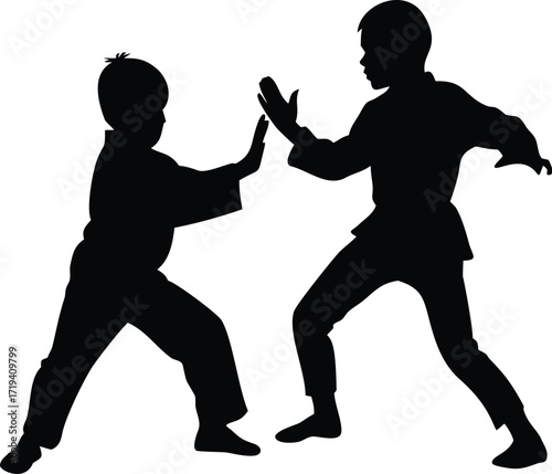 Two children practicing martial arts silhouette