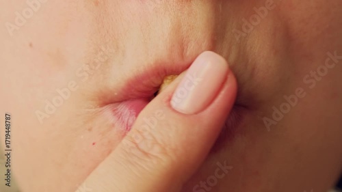 Female lips and mouth eating delicious french fries close up