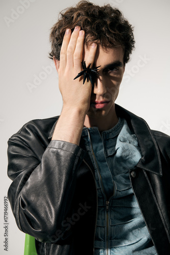 Stylish man captivates with bold fashion choices and striking accessories in urban setting