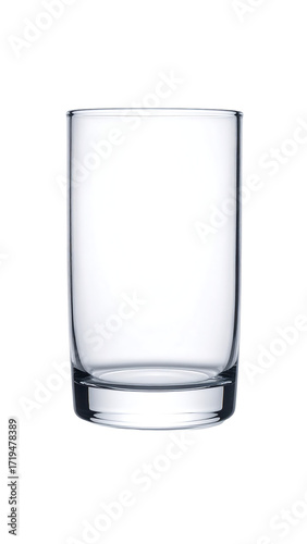 A clear, cylindrical glass, short and stout, with a slightly thicker base, sits empty against a black background