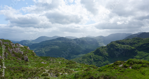 Overlook of lush green mountains in the Gap of Dunloe, County Kerry, Ireland.