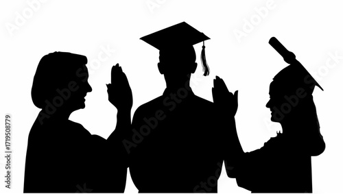 Silhouette of three people in graduation gowns and caps raising their hands in a celebratory gesture