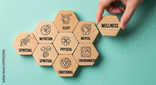 Photo of a hand places the final wellness hexagon tile, completing a mosaic of health concepts like sleep, nutrition, and mental wellbeing