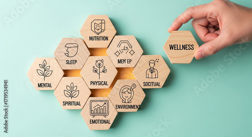 Photo of a hand places the final wellness hexagon tile, completing a diagram of holistic health components