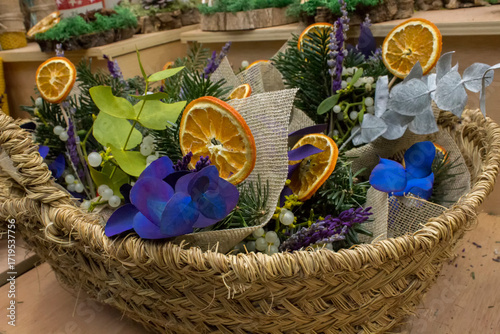 Christmas bouquets with fir branches and dried fruits in a wicker basket